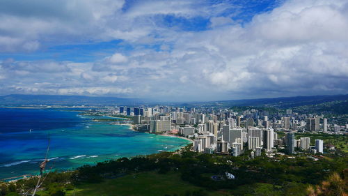 High angle view of buildings and sea against sky