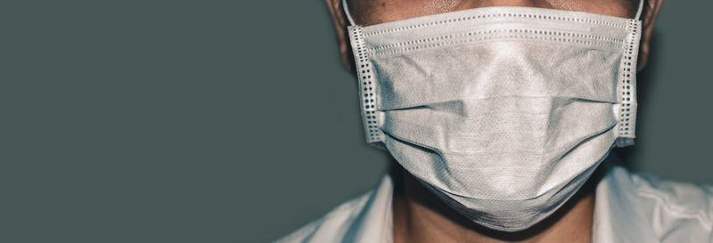 Close-up of man standing against wall