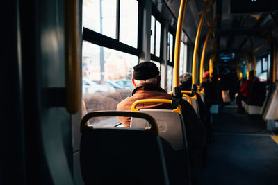 Rear view of man sitting in train