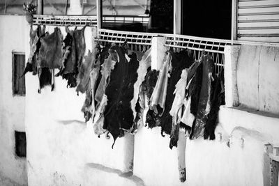 Clothes drying on wall by building
