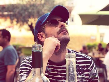 Man looking up while sitting at restaurant