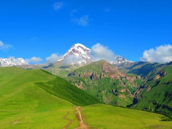 Scenic view of mountains against cloudy sky