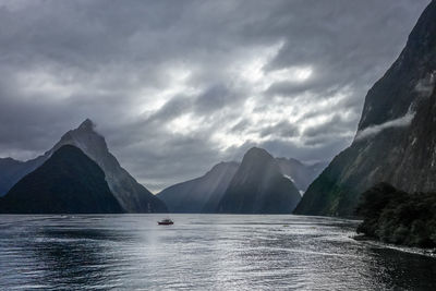 Scenic view of sea and mountains against sky