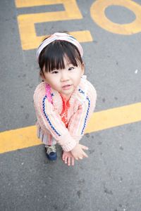 Portrait of cute girl standing on road