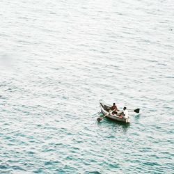 High angle view of people in boat sailing on sea