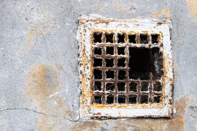 Close-up of old metal window on street