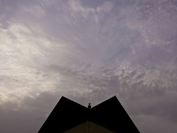 High section of building against cloudy sky