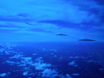 Aerial view of sea against blue sky