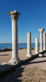 Tauric chersonesos - ancient doric columns on the seashore in chersonese, crimea