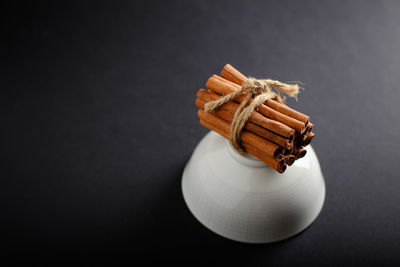 Close-up of flower tied up on table