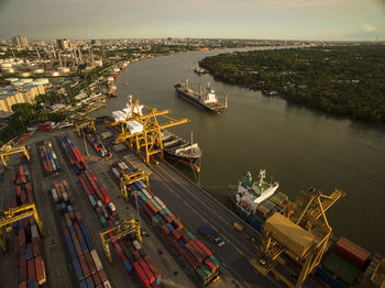 High angle view of cityscape by harbor against sky