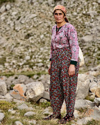 Portrait of woman standing on rock
