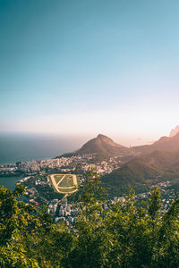 High angle view of town by beach against sky