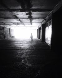 Full length of woman walking in tunnel