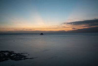 Scenic view of sea against sky at sunset