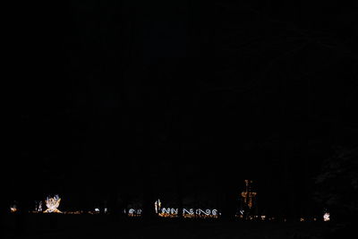 Illuminated city against sky at night