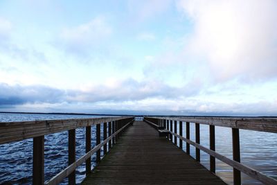 Pier over sea against sky