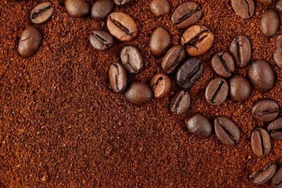 Full frame shot of coffee beans on sand