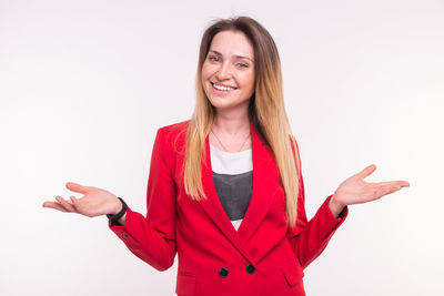 Smiling young woman against white background