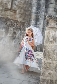 Woman standing against wall