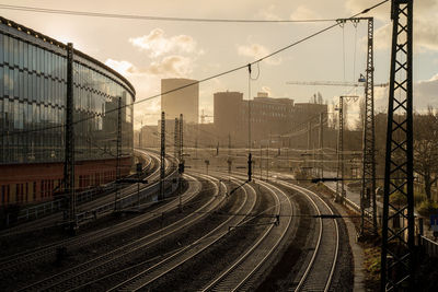 Train on railroad tracks in city against sky