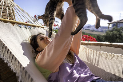 Woman lying down on hammock