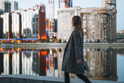 Rear view of woman standing in city