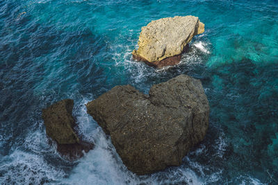 High angle view of rocks in sea