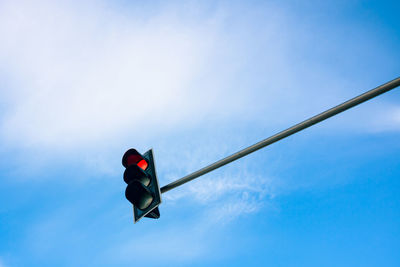 Low angle view of road signal against sky