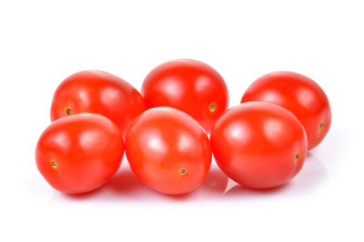 Close-up of tomatoes over white background