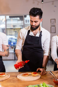 Young man preparing food at home