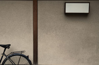 Low angle view of bicycle leaning on wall