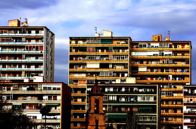 Low angle view of buildings in city against sky