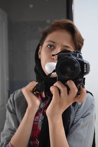 Close-up of woman holding camera