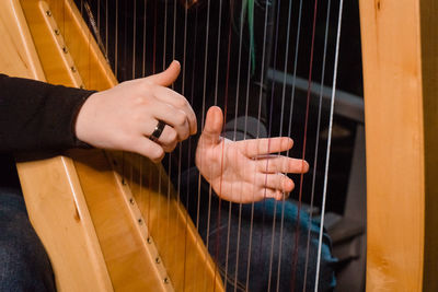 Midsection of man playing piano