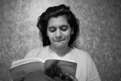 Portrait of woman holding book