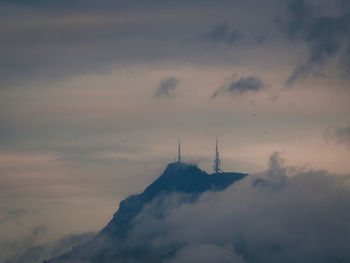 Low angle view of communications tower against sky during sunset