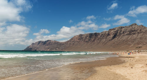 View of beach against cloudy sky