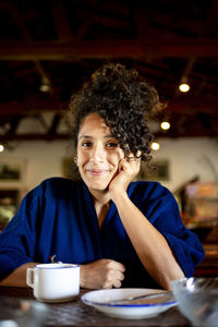 Young woman using mobile phone at restaurant