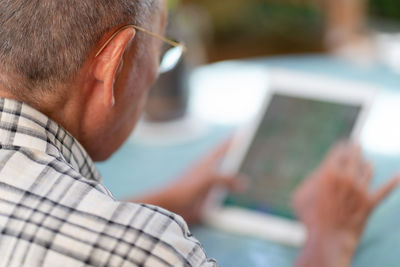 Close-up of man using mobile phone