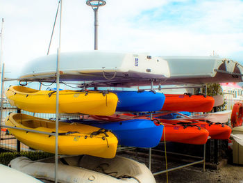 Multi colored boats moored on beach against sky