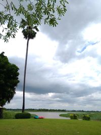 Scenic view of field against cloudy sky