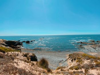 Scenic view of sea against clear blue sky