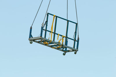 Low angle view of swing against clear sky