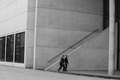 Full length of woman standing in front of building