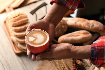 Cropped hands of man holding coffee