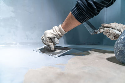 Cropped hand of man working at workshop