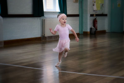 Girl wearing ballet shoe running in dance studio