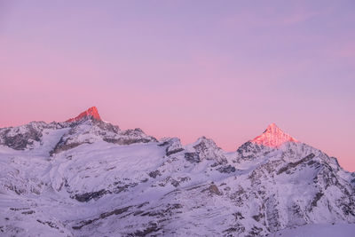 Scenic view of snow covered mountain against dramatic sky