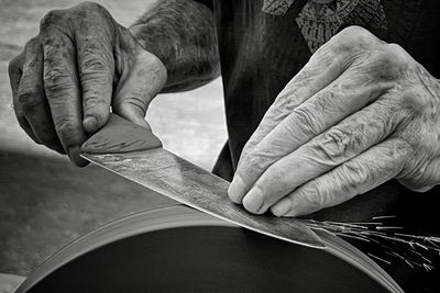 Cropped image of man repairing car